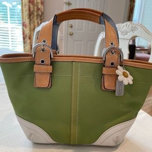 Adorable Coach bag. Eye-catching green and off white with daisy and Coach tag.